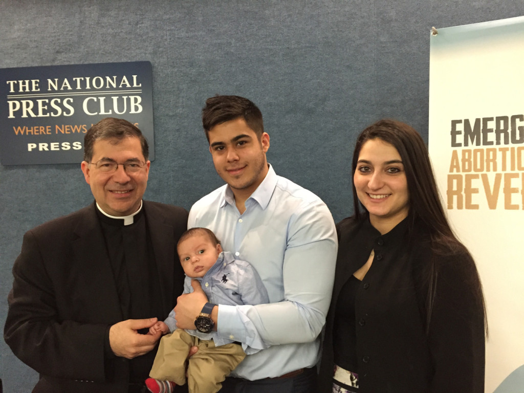 Father Pavone poses with young family following news conference in Washington on RU-486 reversal protocol